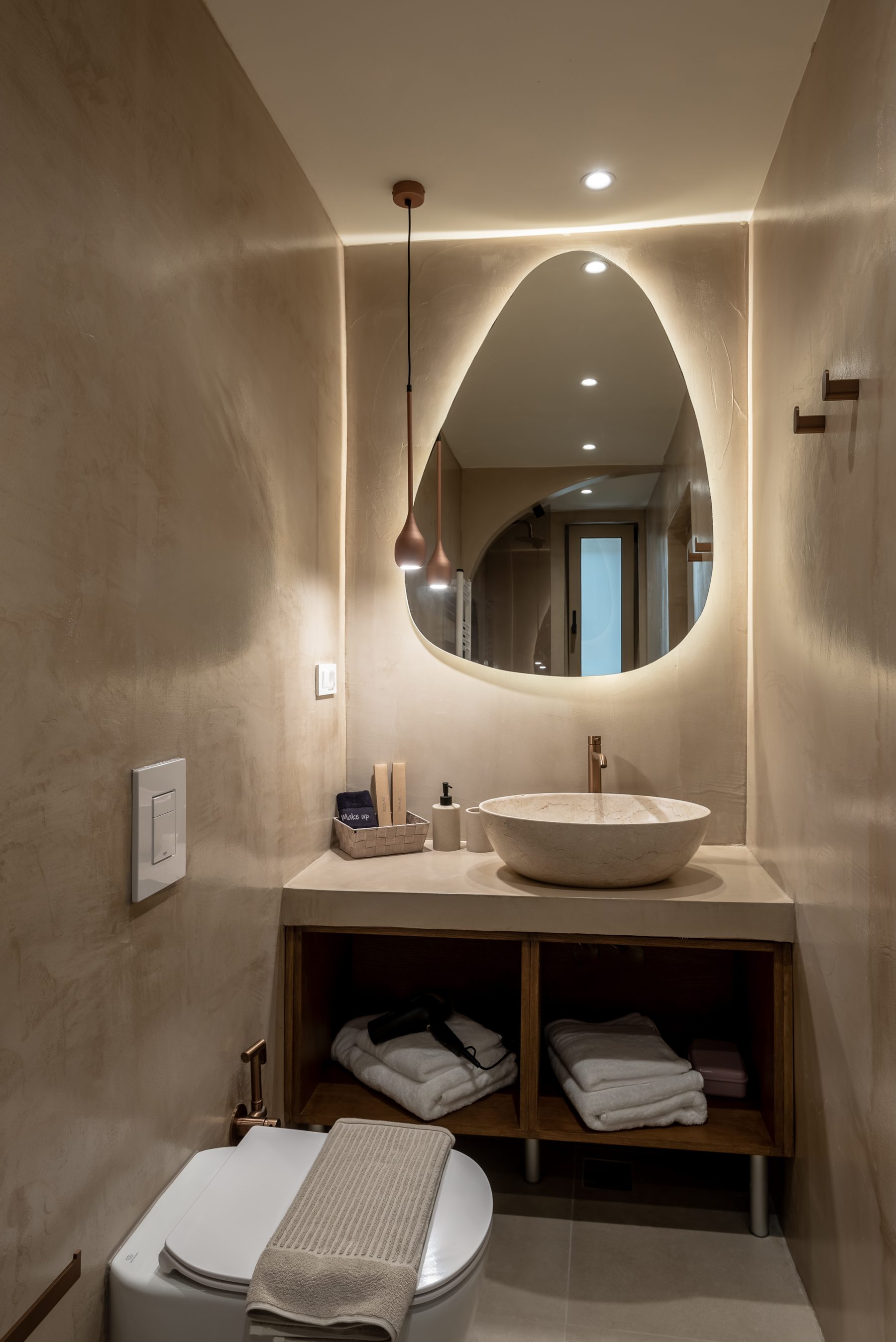 Devina One — backlit mirror and sculptural fixtures