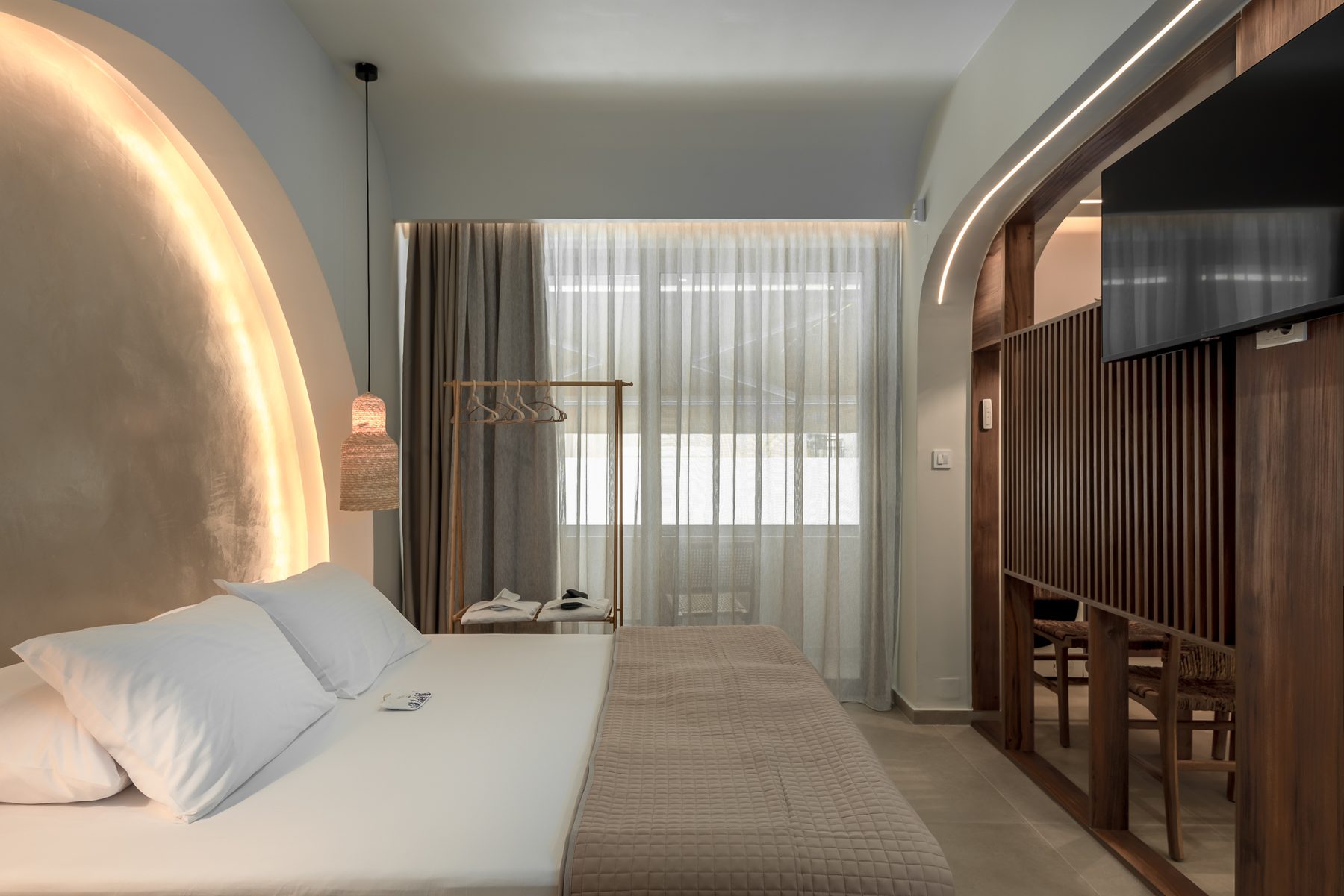 Devina One — bedroom corner with rattan pendants