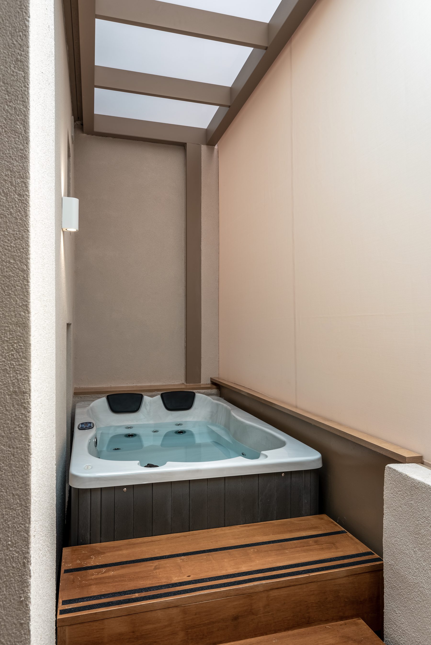 Devina One — jacuzzi with electric awning and evening light