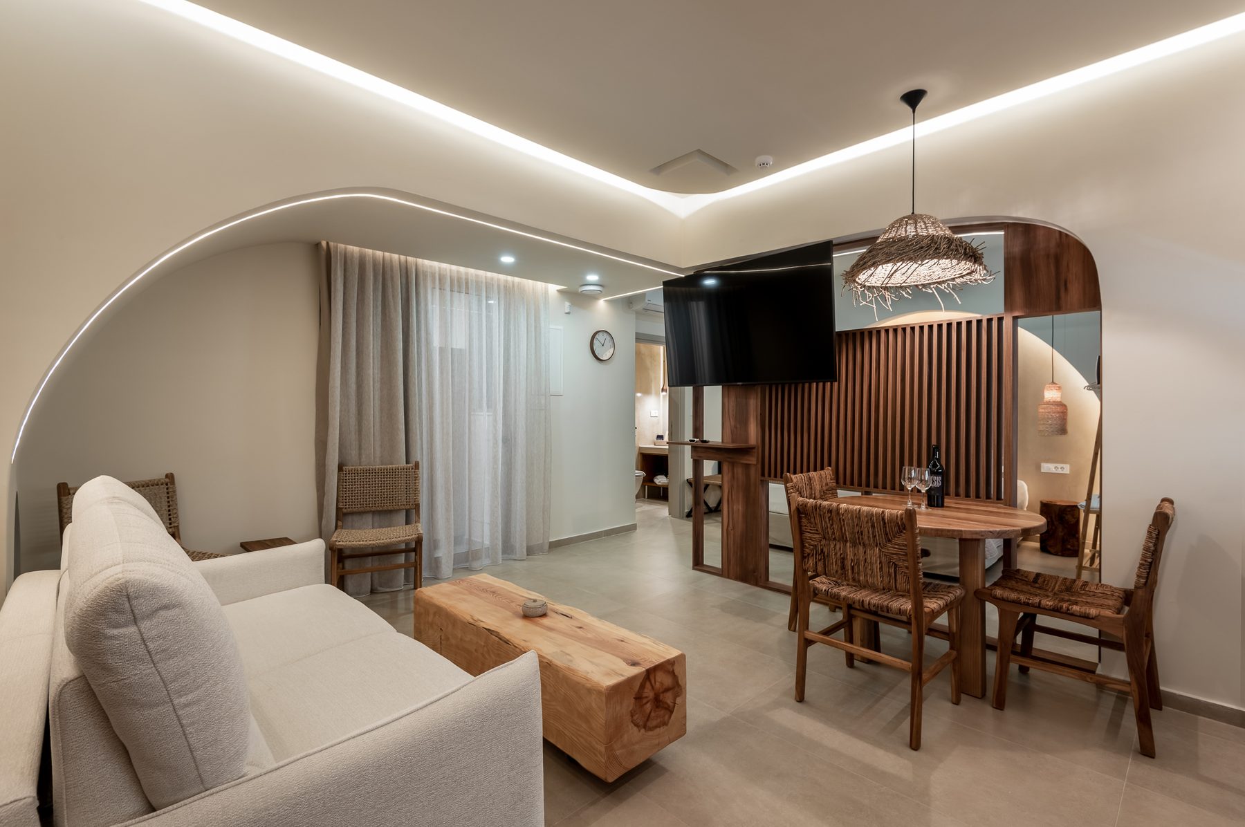 Devina One — living space with arched openings and warm finishes