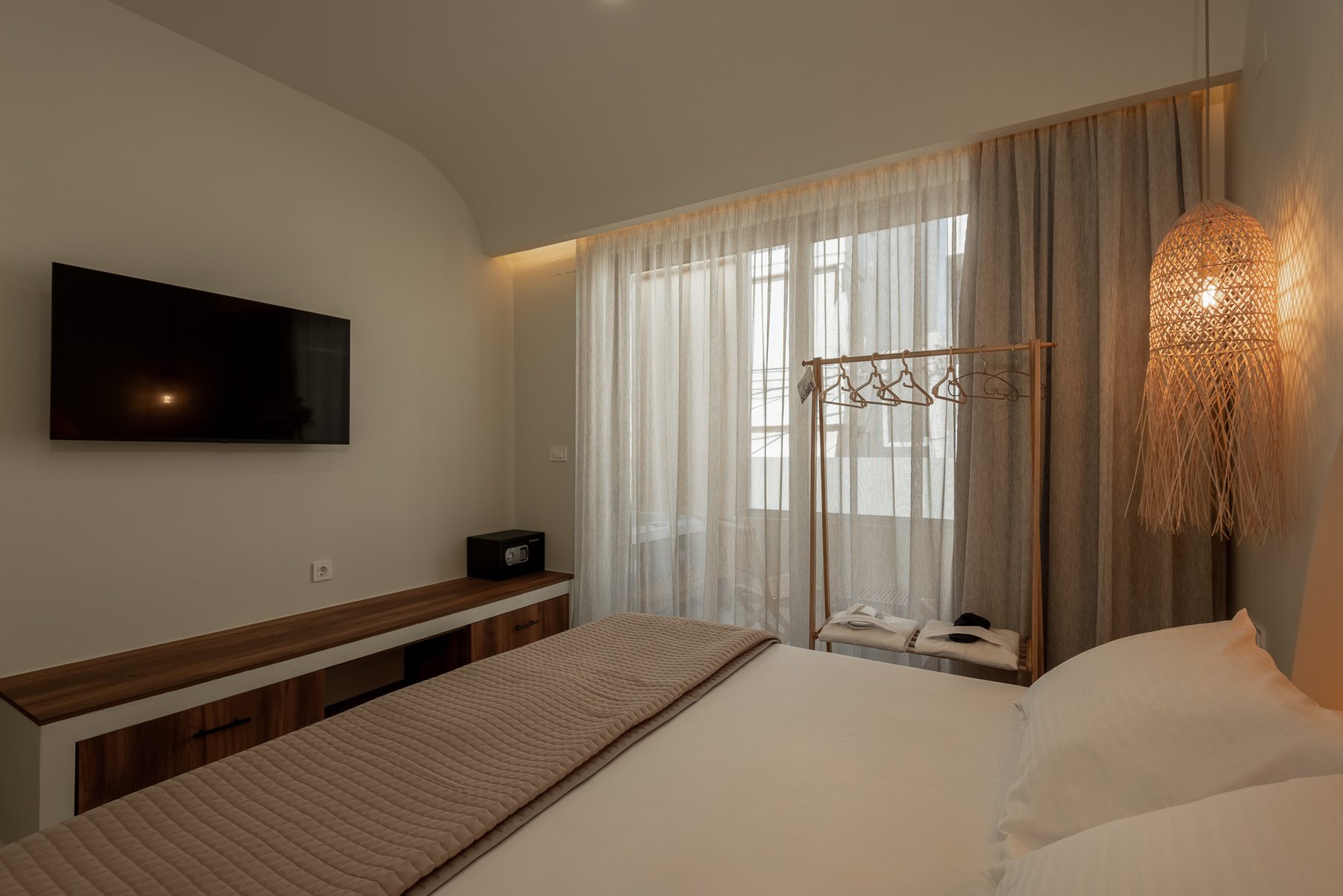 Devina Two — bedroom one corner with rattan pendants